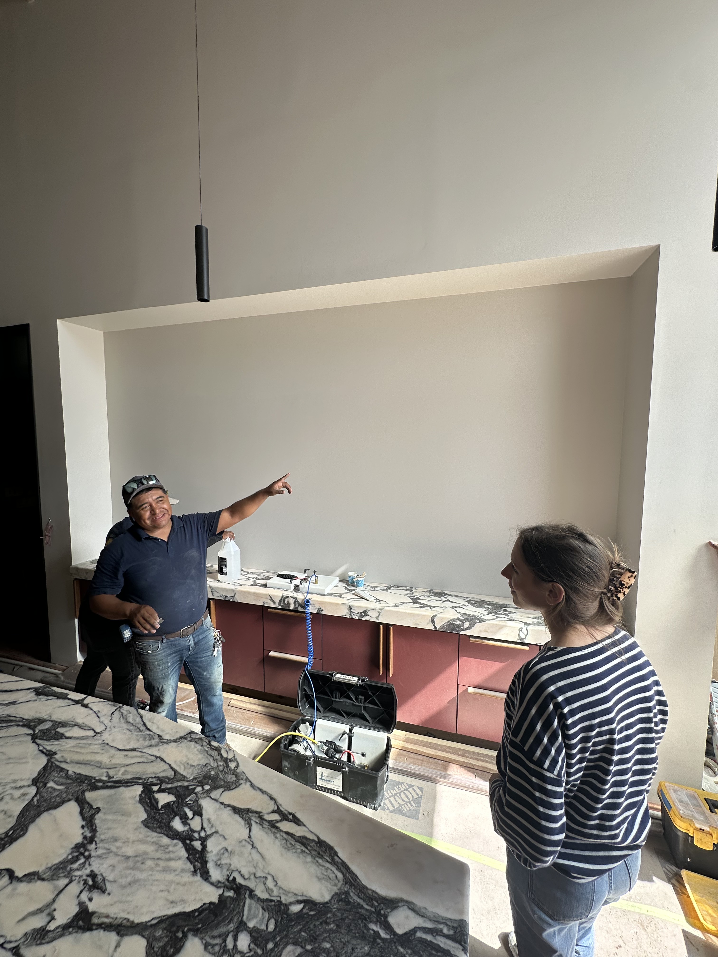 Reviewing marble counters and cabinetry during the Santa Canela build-out