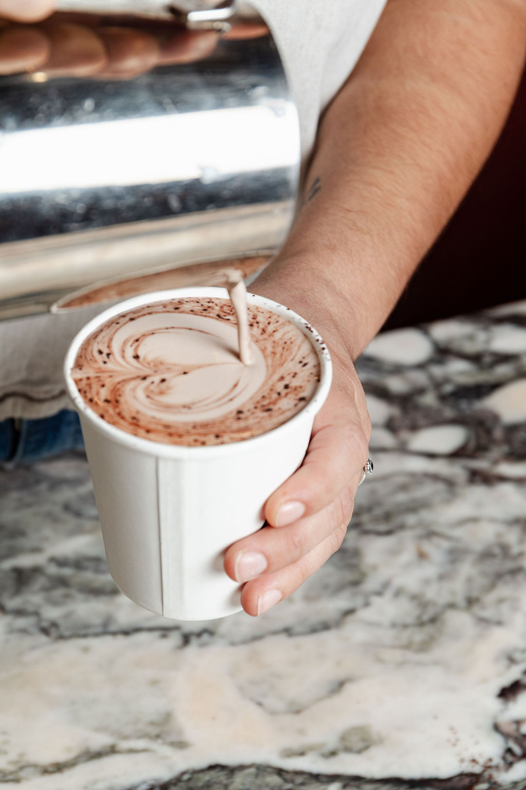 Hot chocolate poured into a cup