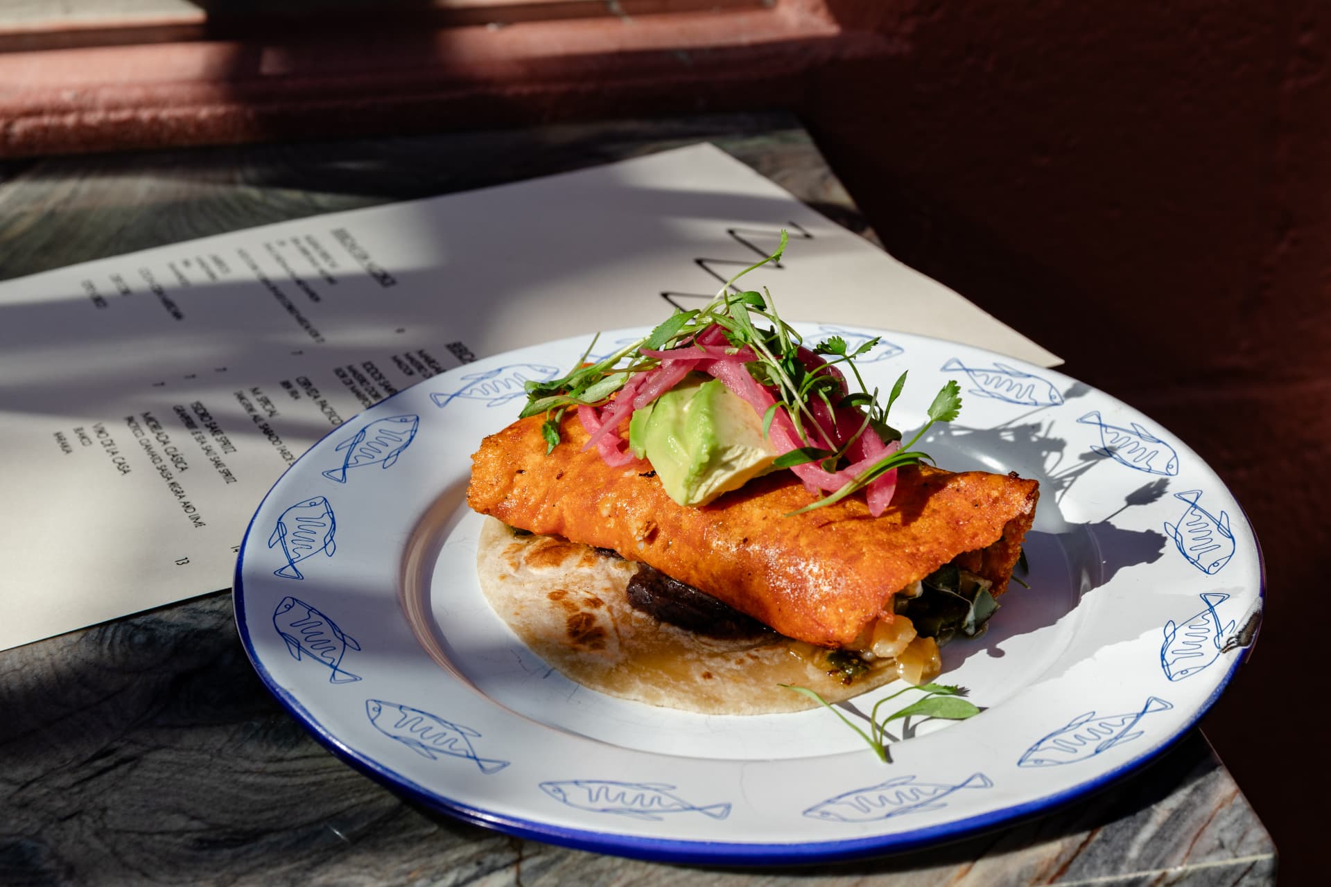 Crisp pescadilla with avocado and pickled onion