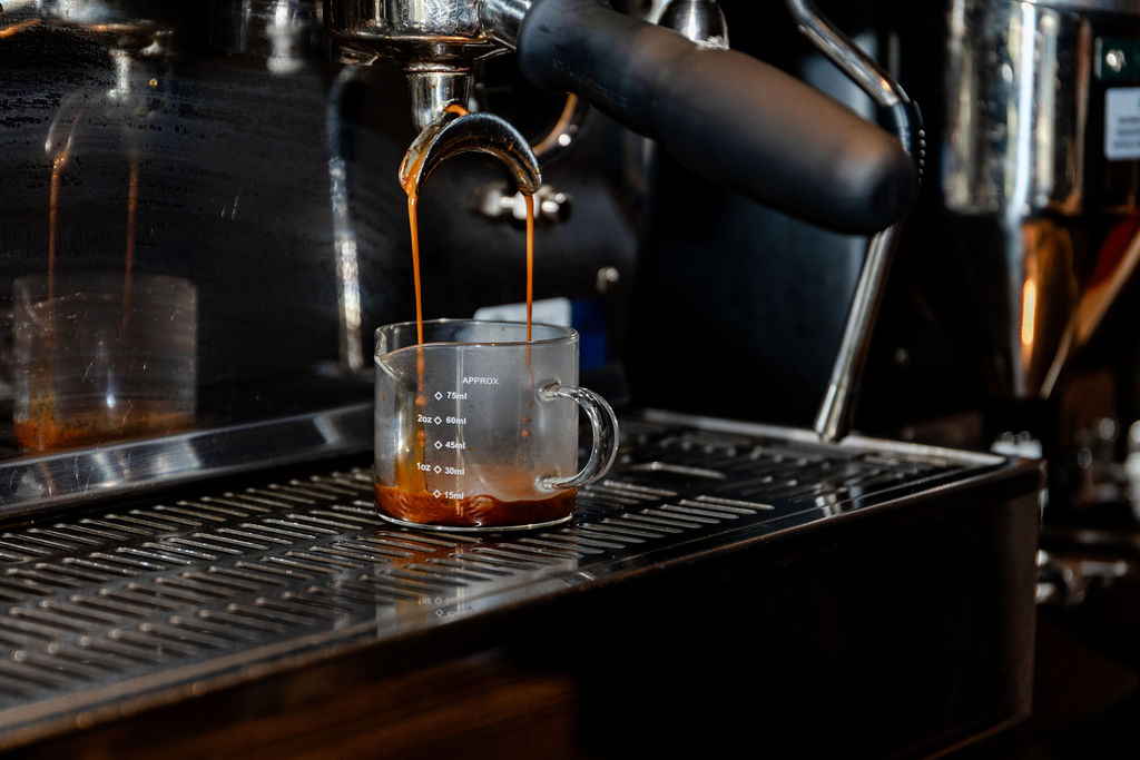 Espresso pulling into a glass pitcher