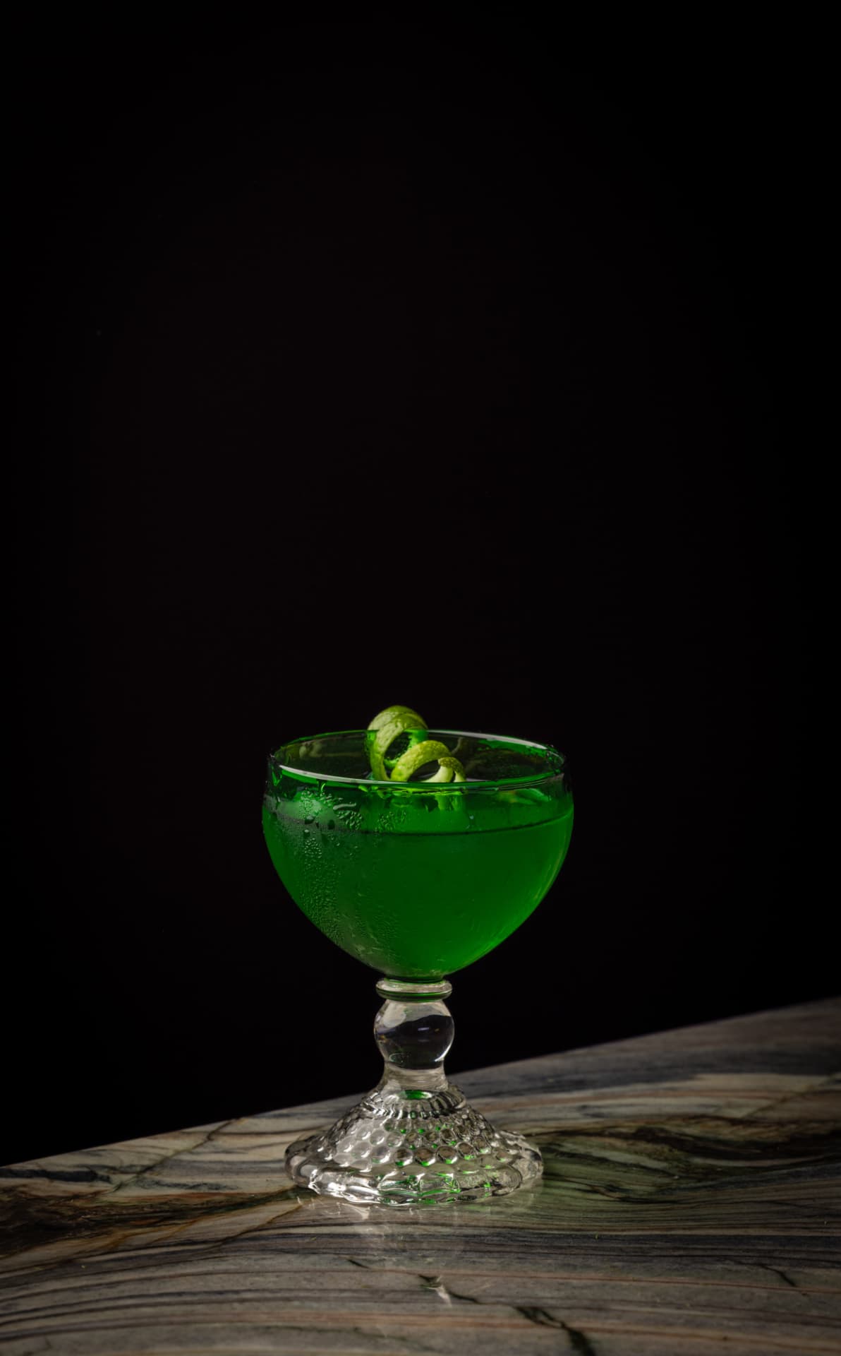 Green cocktail in a coupe