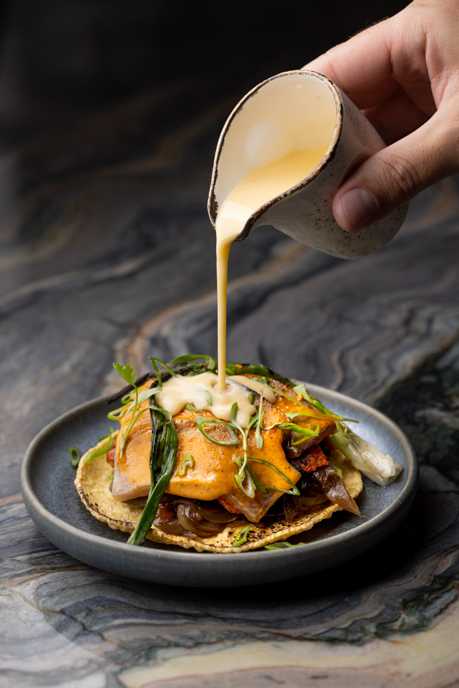 Tostada with sauce poured tableside